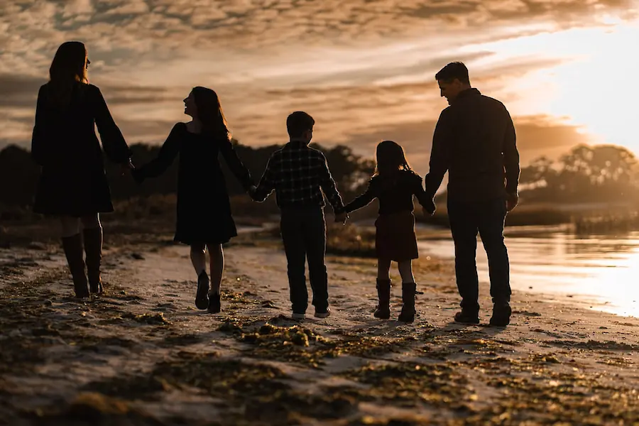 Family walk at sunset. Photo by Chris Hardy, Unsplash.
